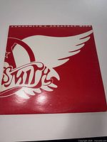 Front of sleeve, red and white Aerosmith logo