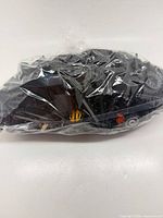 Full bag of assorted LEGO pieces in clear plastic wrap