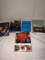 All five books laid out cover facing up