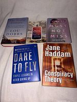 Front covers of five books: The Trump Century, The Dream Peddler, You Must Not Miss, Dare to Fly, Conspiracy Theory