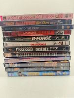 Stack of 13 DVD cases showing spines and titles