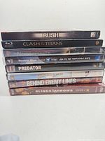 Stack of nine movie and TV discs showing spines with titles