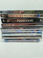 Stack of eight shrink-wrapped DVDs showing readable spines