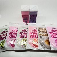 Front view showing six Hemway glitter pouches and two shaker jars