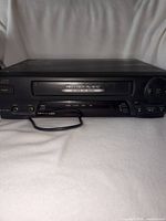 Front view of JVC HR-A33U VCR showing tape slot and controls