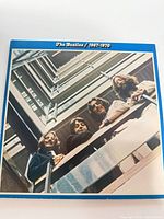 Front cover of the blue box set showing 1967 staircase photo of the band