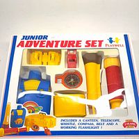 Front view of boxed Playwell Junior Adventure Set showing all components through window