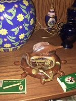 Photo showing vintage nautical ceramic ashtray next to various decorative lighting items