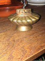Photos show Ronson Regal copper table lighter from multiple angles highlighting patina, wear, and green felt on bottom.