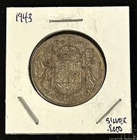 Reverse side of the 1943 Canadian 50 cent silver coin showing Canadian coat of arms and denomination, year.