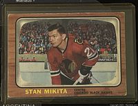 Front of the 1966-67 Topps NHL Stan Mikita hockey card showing Mikita in Chicago Black Hawks red jersey on ice rink.