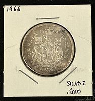 Obverse side showing Canadian coat of arms, date 1966, and silver content marking .8000.