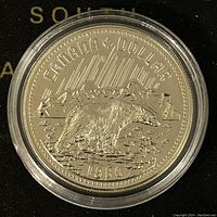 Reverse side showing polar bear design, date 1980, ‘Canada Dollar’ text and mountain background.