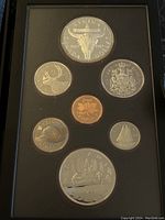 Full view of the 1982 Canadian Silver Proof Double Dollar Coin Set including seven coins arranged in a black holder.