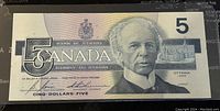 Front side of the 1986 Canadian 5 dollar banknote showing the portrait of Sir Wilfrid Laurier and Parliament buildings.