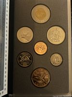 Seven Canadian coins from 1997 specimen set displayed in a case with designs visible
