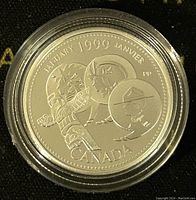 Obverse side of the 1999 Canadian silver proof coin showing the January Millennium design with winter themed artwork and 'JANUARY 1999 JANVIER CANADA'. Coin encased in clear protective capsule.