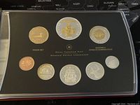 Obverse and reverse of proof set in clear tray showing all eight coins