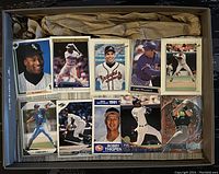 Box with a selection of about 10 baseball cards displayed including Bobby Thigpen 1991 card and players from White Sox, Braves, Royals and Athletics.