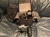 Open padded black carrying bag showing interior compartments and accessories