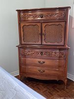 Front view of entire chest showing two-piece design with upper cabinet and lower drawers