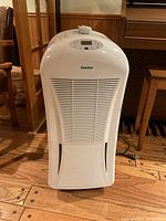 Front view of white Danby dehumidifier showing vented front panel and control panel on top.
