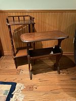 Photo showing two wooden stands, one with turned spindle vertical supports and top edge trim, the other with curved sides and decorative circular side accents.