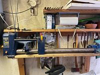 Overall view of wood lathe mounted on shelf showing headstock, bed, tool rest and tailstock
