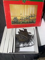 Open box showing Santa sleigh figurine and divider trays inside box