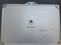 Closed metal carrying case showing HP Deskjet 450 mobile printer Platinum Edition label