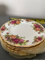 Stack of five vintage Royal Albert Old Country Roses sandwich plates showing floral pattern and gold rim.