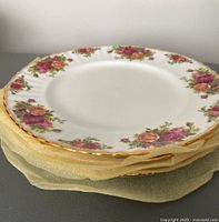 Stack of five Royal Albert Old Country Rose dinner plates showing floral pattern with pink and orange roses and gold trim.