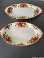 Two vintage Old Country Rose porcelain serving trays, one larger and one smaller, displayed on gray surface.