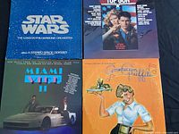 Photo showing the covers of Star Wars, Top Gun, Miami Vice II, American Graffiti vinyl soundtracks.