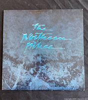 Front cover of vinyl record album by The Northern Pikes showing dark marbled background with blue metallic text.