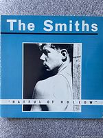 Front cover of the vinyl album 'Hatful of Hollow' by The Smiths showing the blue background with black and white photo of a man in profile.