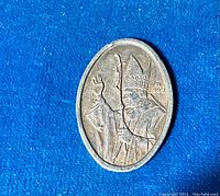 Oblong silver medal front side showing the Pope in robes with a staff and purity mark '.999'