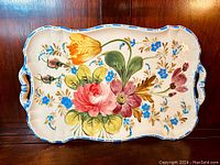 Full view of rectangular majolica tray platter showing floral design, handles, and scalloped edges.