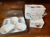 Overview of serving pieces including the white divided ceramic serving dish in box and two glass sauce boats in their boxes