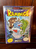 Front view of the Rampage NES box showing colorful game artwork and branding.