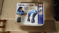 Closed box of DR-HOS Neck Pain Pro showing product features and benefits including headache relief, neck pain, shoulder pain, muscle relaxation, and improved circulation.