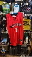 Front view of red Raptors jersey with number 7 and team name across the chest.