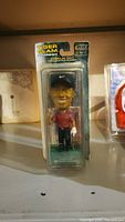 Photo of the packaged Tiger Woods bobblehead from front, showing figure and packaging details