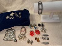 Overall grouping on fabric surface showing mesh purse, agate box, earrings, ring and hair clips.