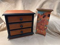 Front view of the two jewelry boxes showing the three-drawer box and the painted floral cabinet