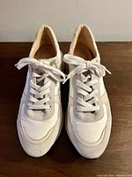Top front view of white and grey L'Intervalle sneakers showing lace-up front and suede details