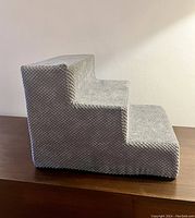 Side view of the 3-step pet stairs showing textured light gray fabric outer cover.