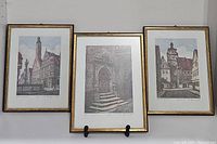 Three of the framed art prints displayed side-by-side showing various Rothenburg Tauber scenes with gold frames