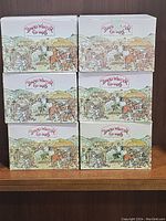 Six David Winter cottage boxes stacked in two columns of three, showing consistent branding and artwork.