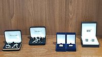 Four sets of cufflinks displayed in original boxes from left to right: Pronto Uomo, Today's Man, two others including Montblanc